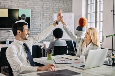 happy-business-people-supporting-each-other-giving-high-five-office